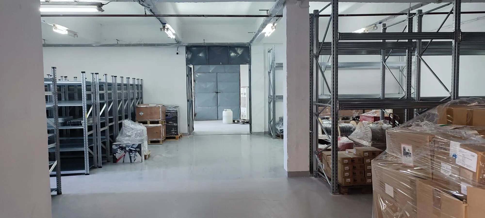 Warehouse with metal shelves and packed pallets